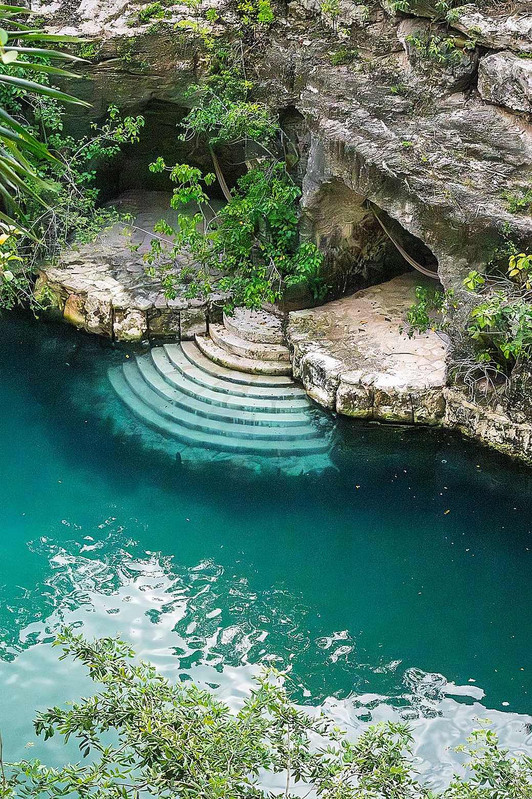 Swimmer in the turquoise water of a natural cave
