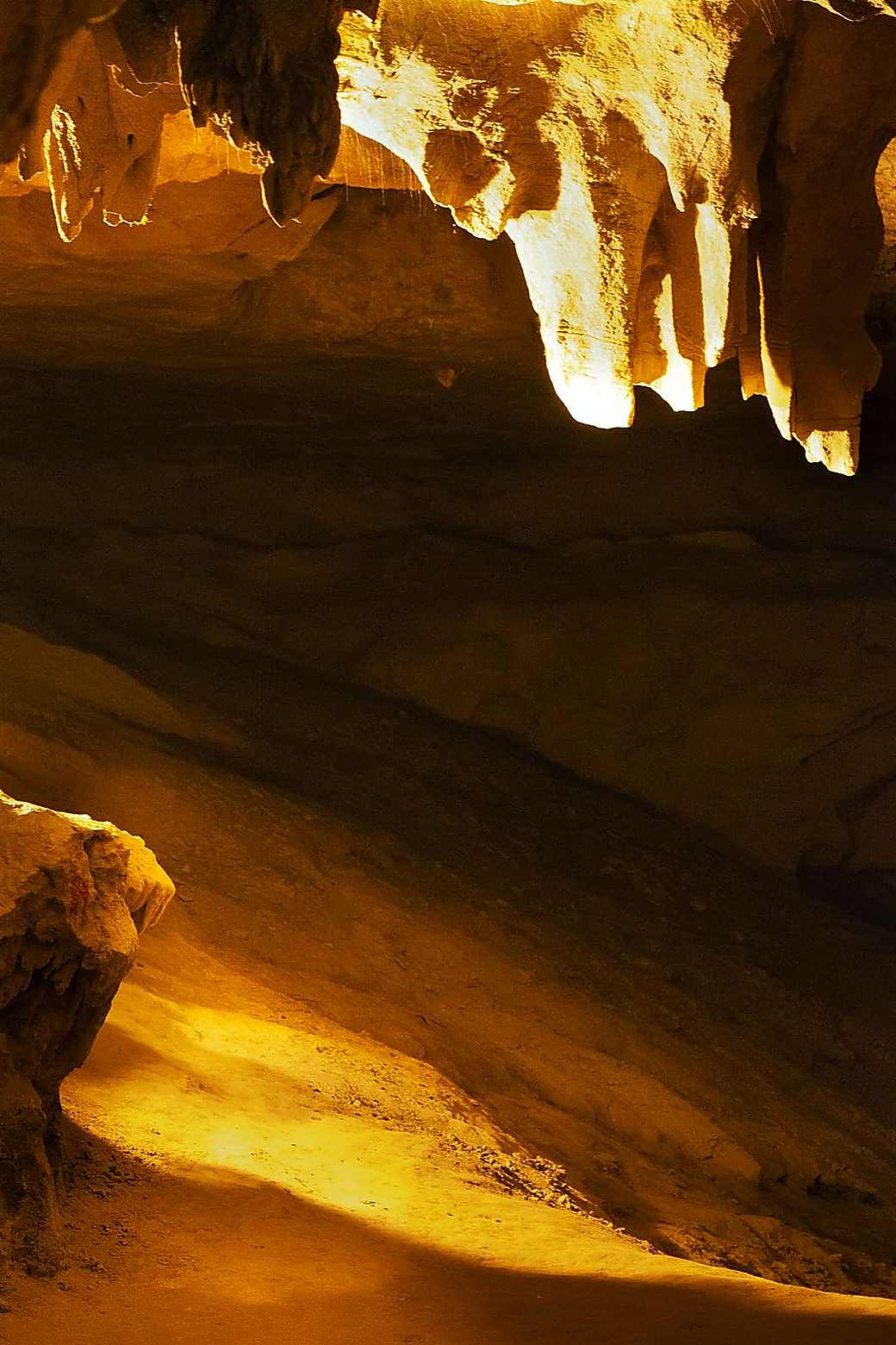 Light falling on rock formations inside a cave